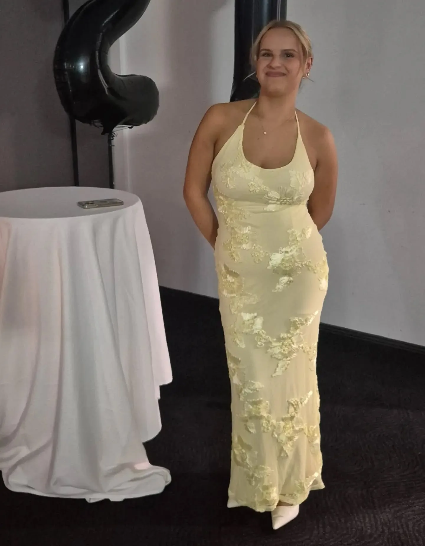 Client in a golden full-length gown, glowing bronze tan