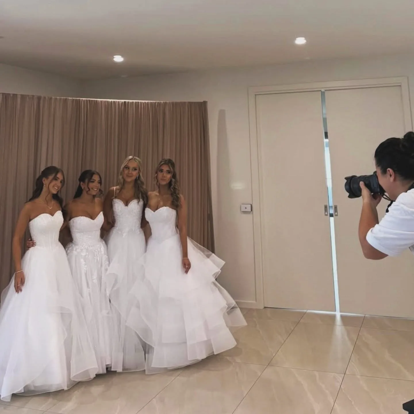 Four young women in white gowns, glam line-up