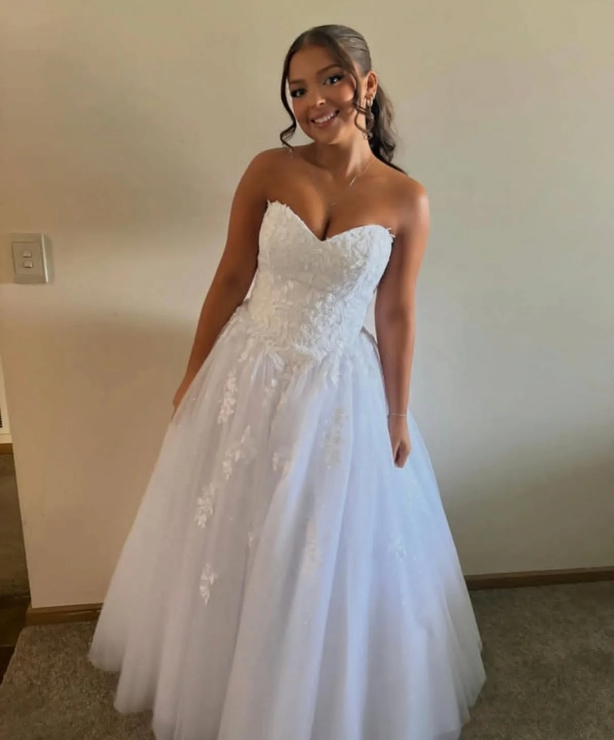 Debutante group with chaperones at an event, tanned arms and shoulders